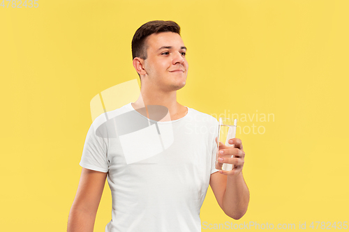 Image of Caucasian young man\'s half-length portrait on yellow background