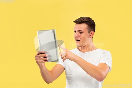 Image of Caucasian young man\'s half-length portrait on yellow background