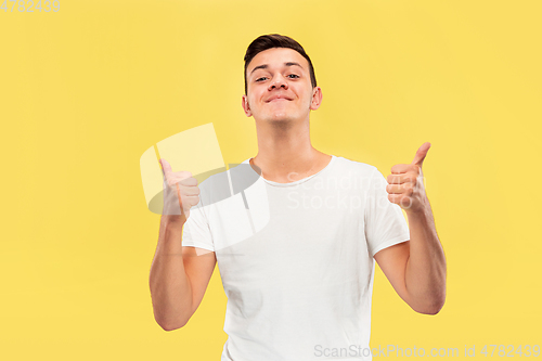 Image of Caucasian young man\'s half-length portrait on yellow background
