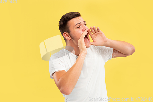 Image of Caucasian young man\'s half-length portrait on yellow background