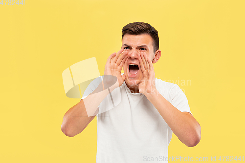 Image of Caucasian young man\'s half-length portrait on yellow background