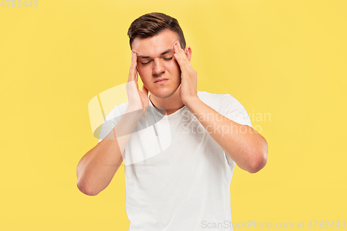 Image of Caucasian young man\'s half-length portrait on yellow background