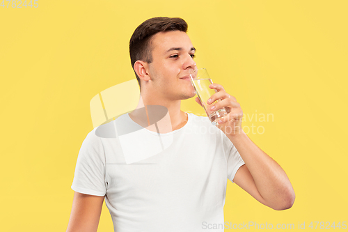 Image of Caucasian young man\'s half-length portrait on yellow background