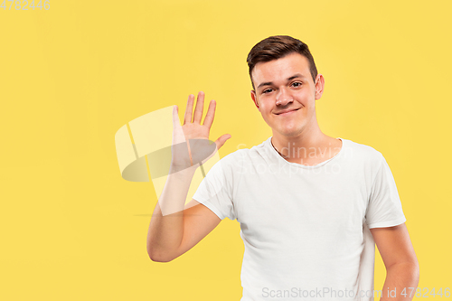 Image of Caucasian young man\'s half-length portrait on yellow background