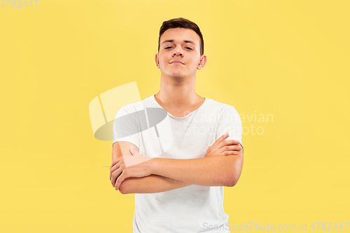 Image of Caucasian young man\'s half-length portrait on yellow background