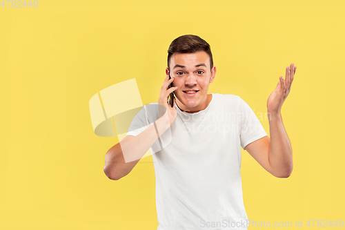 Image of Caucasian young man\'s half-length portrait on yellow background