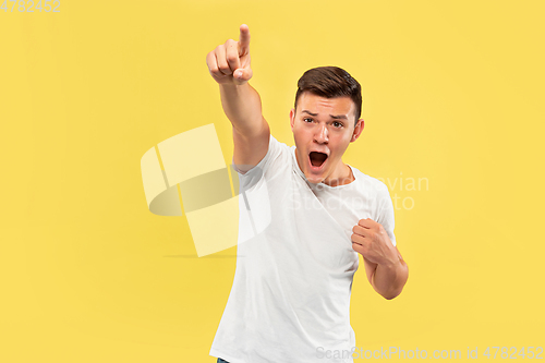 Image of Caucasian young man\'s half-length portrait on yellow background
