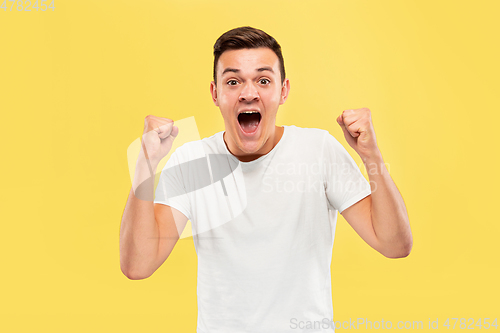 Image of Caucasian young man\'s half-length portrait on yellow background