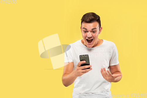 Image of Caucasian young man\'s half-length portrait on yellow background