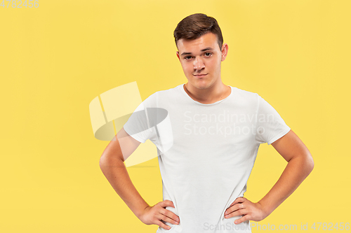 Image of Caucasian young man\'s half-length portrait on yellow background