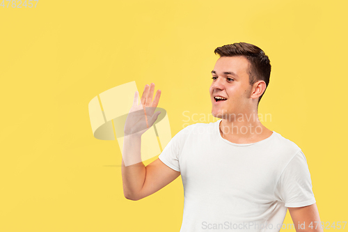 Image of Caucasian young man\'s half-length portrait on yellow background