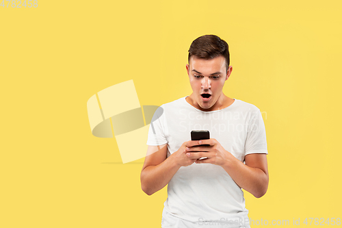 Image of Caucasian young man\'s half-length portrait on yellow background