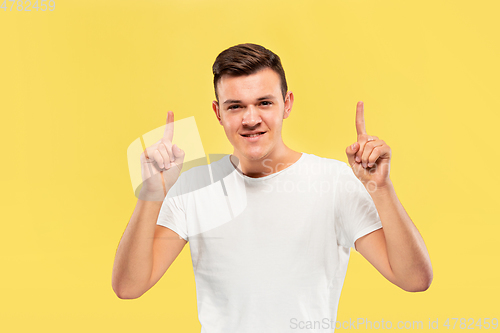 Image of Caucasian young man\'s half-length portrait on yellow background
