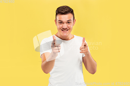 Image of Caucasian young man\'s half-length portrait on yellow background
