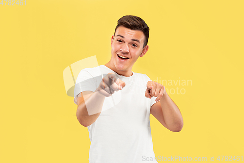 Image of Caucasian young man\'s half-length portrait on yellow background
