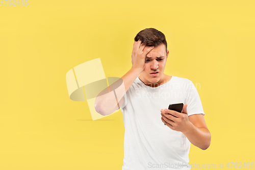 Image of Caucasian young man\'s half-length portrait on yellow background