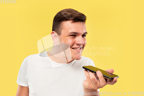 Image of Caucasian young man\'s half-length portrait on yellow background