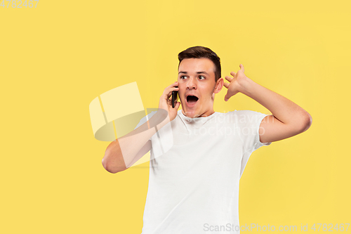Image of Caucasian young man\'s half-length portrait on yellow background