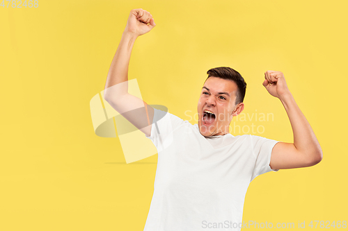 Image of Caucasian young man\'s half-length portrait on yellow background
