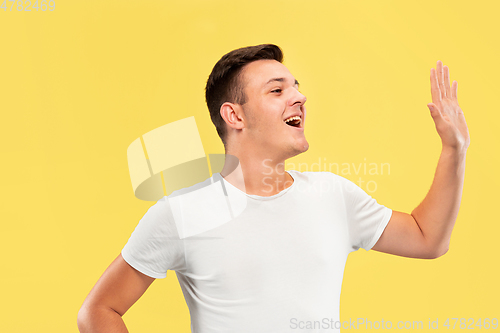 Image of Caucasian young man\'s half-length portrait on yellow background