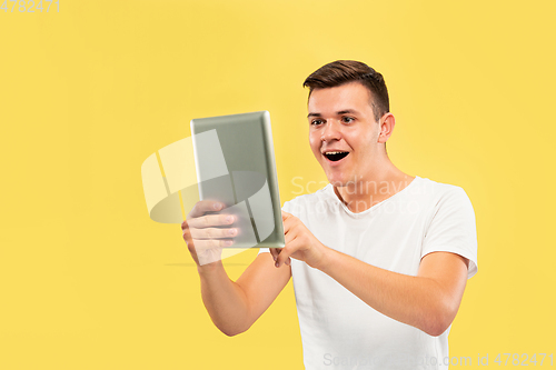 Image of Caucasian young man\'s half-length portrait on yellow background