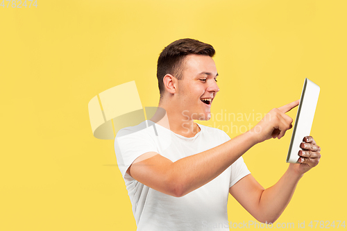 Image of Caucasian young man\'s half-length portrait on yellow background
