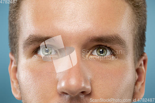 Image of Caucasian young man\'s close up portrait on blue background