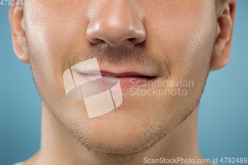 Image of Caucasian young man\'s close up portrait on blue background