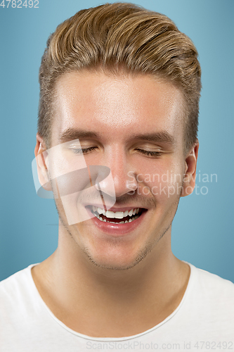 Image of Caucasian young man\'s close up portrait on blue background