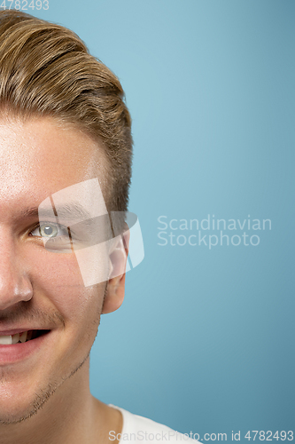 Image of Caucasian young man\'s close up portrait on blue background