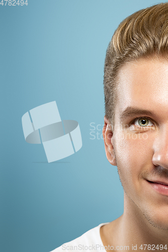 Image of Caucasian young man\'s close up portrait on blue background