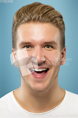 Image of Caucasian young man\'s close up portrait on blue background