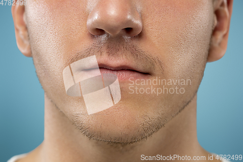 Image of Caucasian young man\'s close up portrait on blue background