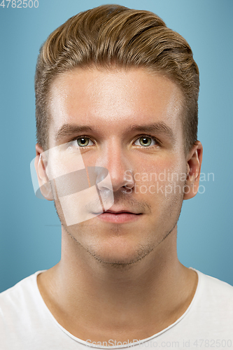 Image of Caucasian young man\'s close up portrait on blue background