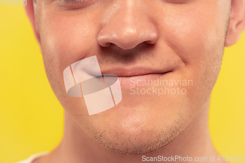 Image of Caucasian young man\'s close up portrait on yellow background