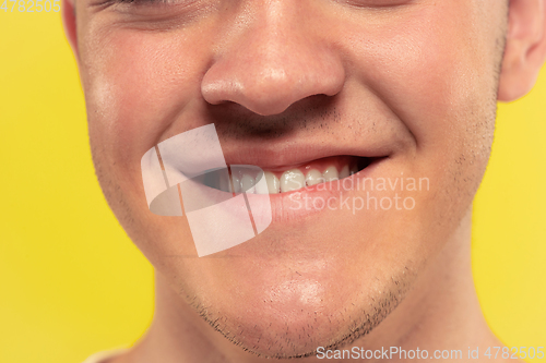 Image of Caucasian young man\'s close up portrait on yellow background