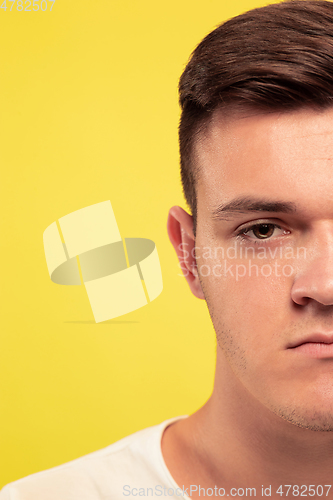Image of Caucasian young man\'s close up portrait on yellow background