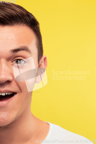 Image of Caucasian young man\'s close up portrait on yellow background