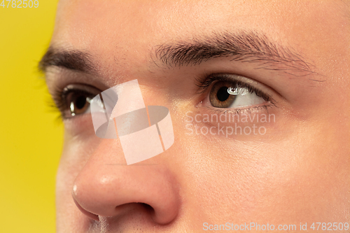 Image of Caucasian young man\'s close up portrait on yellow background
