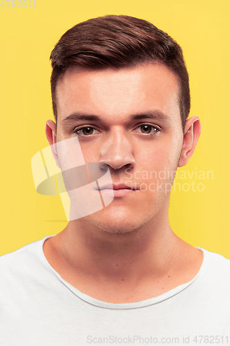 Image of Caucasian young man\'s close up portrait on yellow background