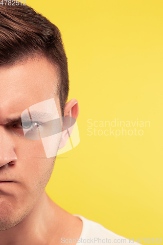 Image of Caucasian young man\'s close up portrait on yellow background