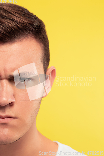 Image of Caucasian young man\'s close up portrait on yellow background