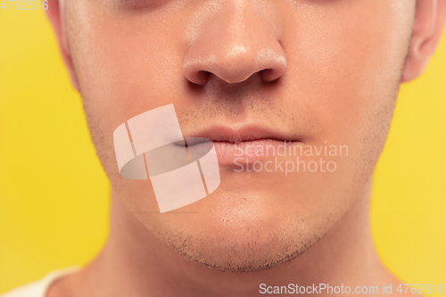 Image of Caucasian young man\'s close up portrait on yellow background