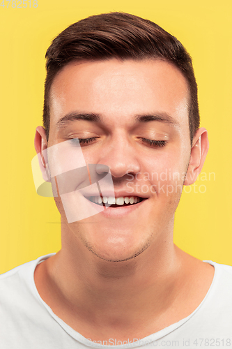 Image of Caucasian young man\'s close up portrait on yellow background