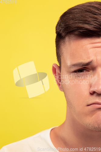 Image of Caucasian young man\'s close up portrait on yellow background