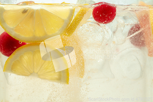 Image of Close up view of the lemon slices in lemonade on background