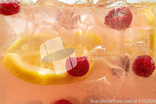 Image of Close up view of the lemon slices in lemonade on background