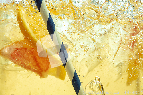 Image of Close up view of the lemon slices in lemonade on background