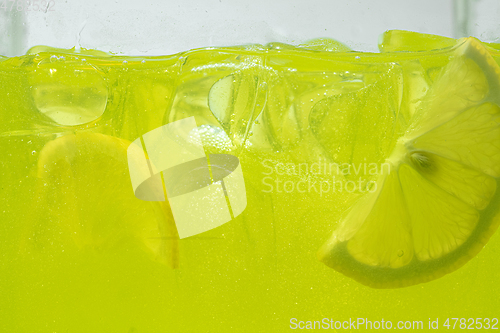 Image of Close up view of the lemon slices in lemonade on background