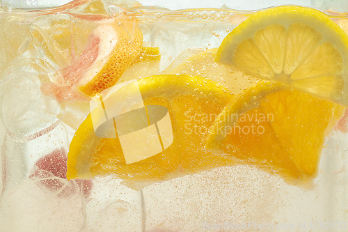 Image of Close up view of the lemon slices in lemonade on background